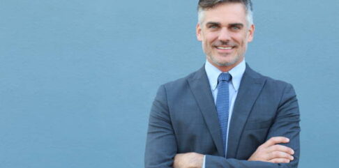 Mature businessman smiling wearing classic suit.