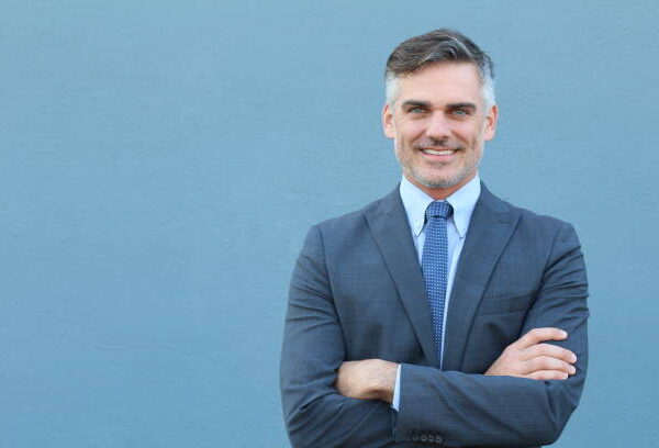 Mature businessman smiling wearing classic suit.